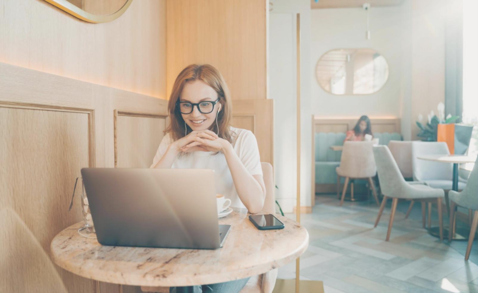 Workshop participants collaborating on financial model design with laptops and printed scenario analysis